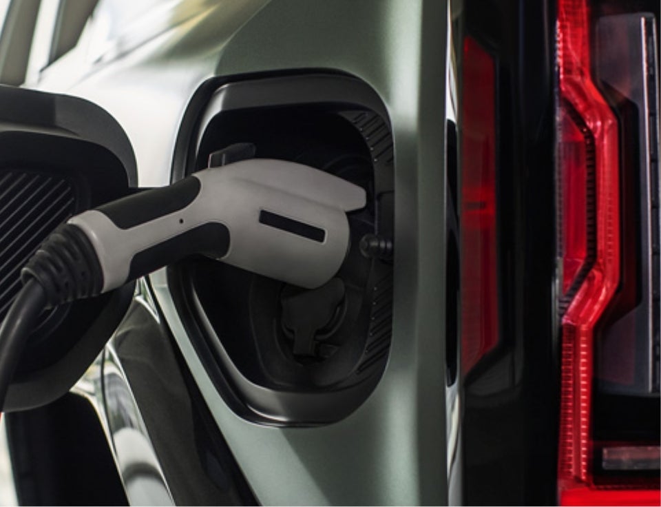 Close up of charging port with charger plugged in on a GMC Hummer EV SUV - Geoff Penske GMC in SHILLINGTON PA